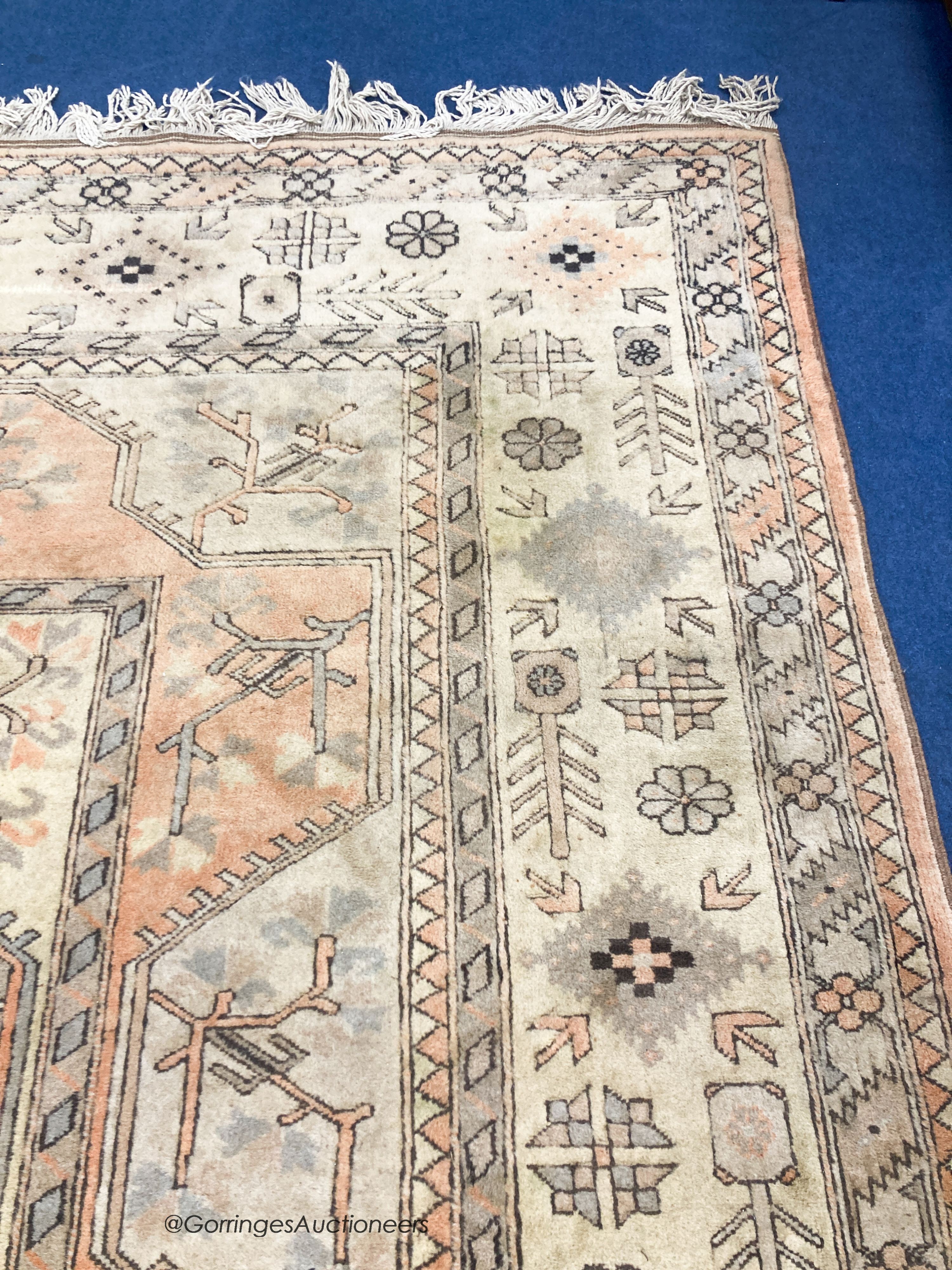 A large Caucasian Turkish design fawn ground carpet, 420 x 300cm